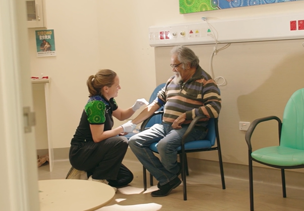 A nurse prepares a patient for a blood glucose test